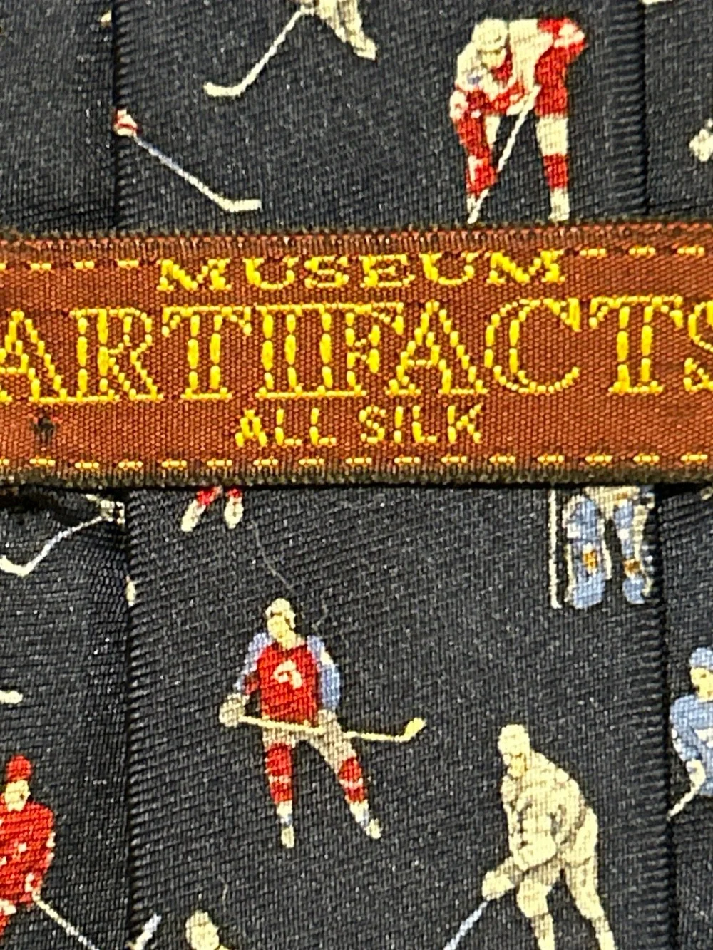 Museum Artifacts Silk Tie with Red, Cream, Blue and Gray Hockey Player Motif